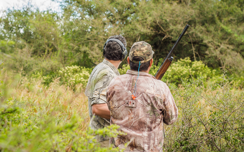 A guest and guide looking across open country