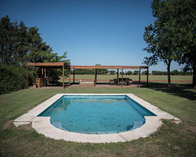 Swimming pool and field view at Estancia La Faustina